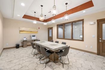 A dining room with a table and chairs